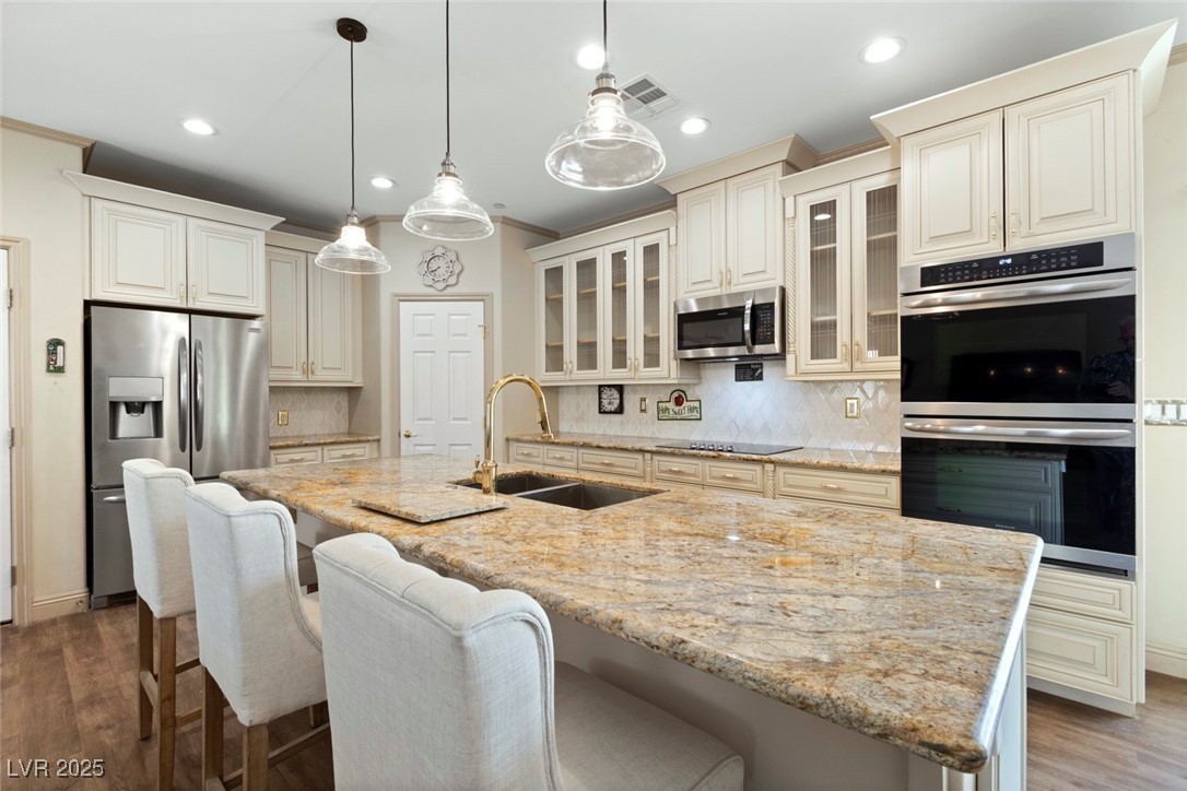 5315 North Fort Apache Road Las Vegas, NV 89149 - Photo 21 of 46 Kitchen with Stainless Steel appliances, and breakfast bar Countertop with a Gold-tone Faucet.