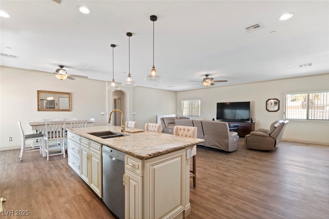 5315 North Fort Apache Road Las Vegas, NV 89149 - Photo 23 of 46 Kitchen featuring dishwasher, ceiling fan, a sink, cream cabinets, and recessed lighting. This Stainless Steel BOSCH Digital Dishwasher's Model Number is: BOSCH SHE3AR75UC/26FD000807631