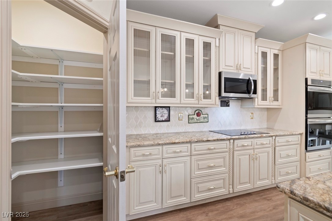 5315 North Fort Apache Road Las Vegas, NV 89149 - Photo 24 of 46 Kitchen featuring a walk in Custom shelved Pantry.