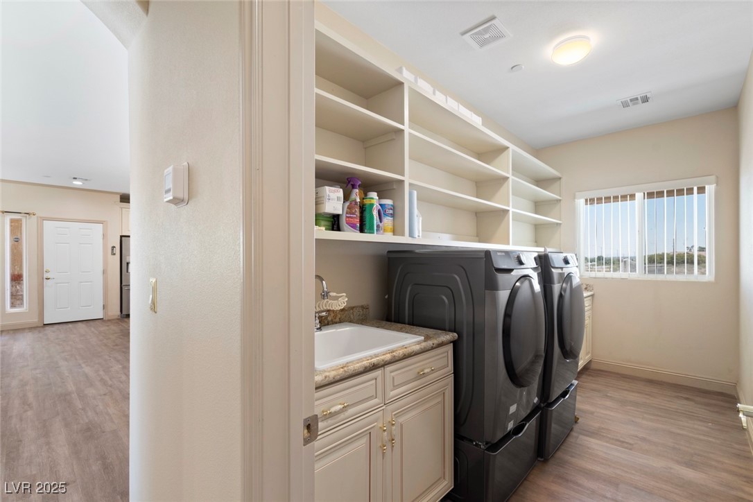 5315 North Fort Apache Road Las Vegas, NV 89149 - Photo 27 of 46 Laundry room (14x6 foot) featuring Samsung independent washer and dryer, with extra custom shelving and storage.