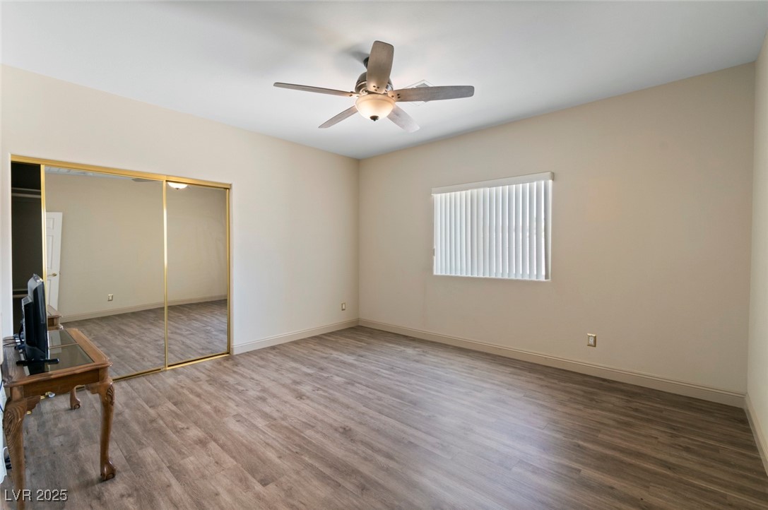 5315 North Fort Apache Road Las Vegas, NV 89149 - Photo 29 of 46 Unfurnished 15x14 foot bedroom featuring Luxury Vinyl Plank Flooring, a mirrored closet, & internet/Cable hook ups.
