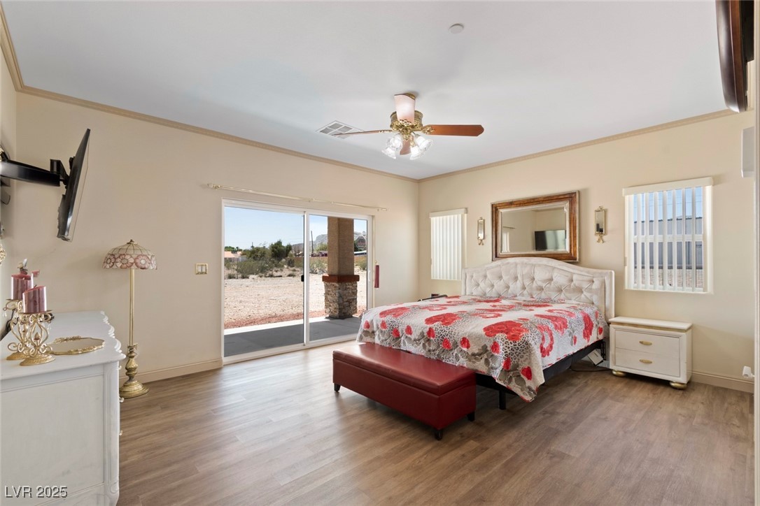 5315 North Fort Apache Road Las Vegas, NV 89149 - Photo 34 of 46 Primary 17x14 Foot Bedroom with Glass Slider access to outside covered patio, 55" Adjustable Attached Samsung Flat Screen, & Ashley Adjustible California King Pillow Top Bed.
