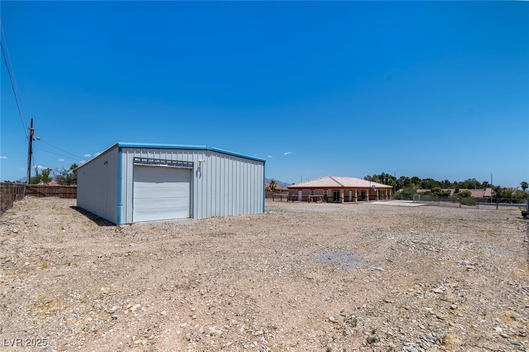 5315 North Fort Apache Road Las Vegas, NV 89149 - Photo 41 of 46 Southwest Corner of Lot showcasing 60X30 Foot Metal Garage with Roll up garage door.