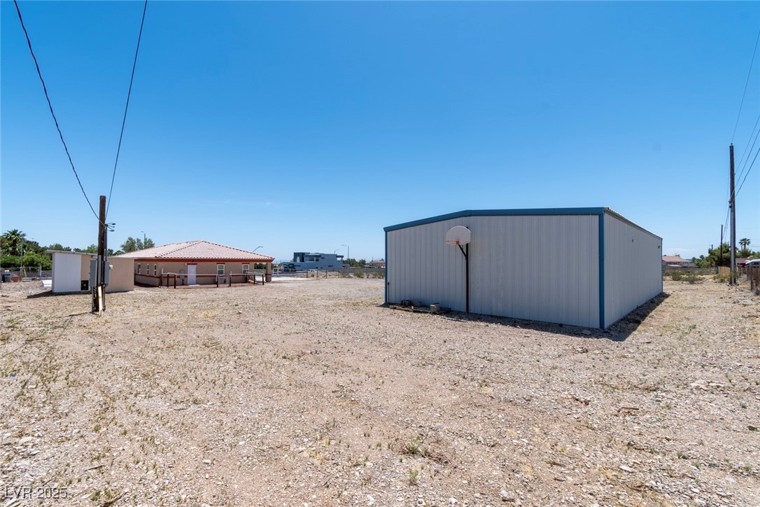 5315 North Fort Apache Road Las Vegas, NV 89149 - Photo 42 of 46 Northwest Corner View of Lot showcasing 1800 SF Metal Garage, Back of Home, and Wood Shed with Well & Safety Fire Sprinkler System.
