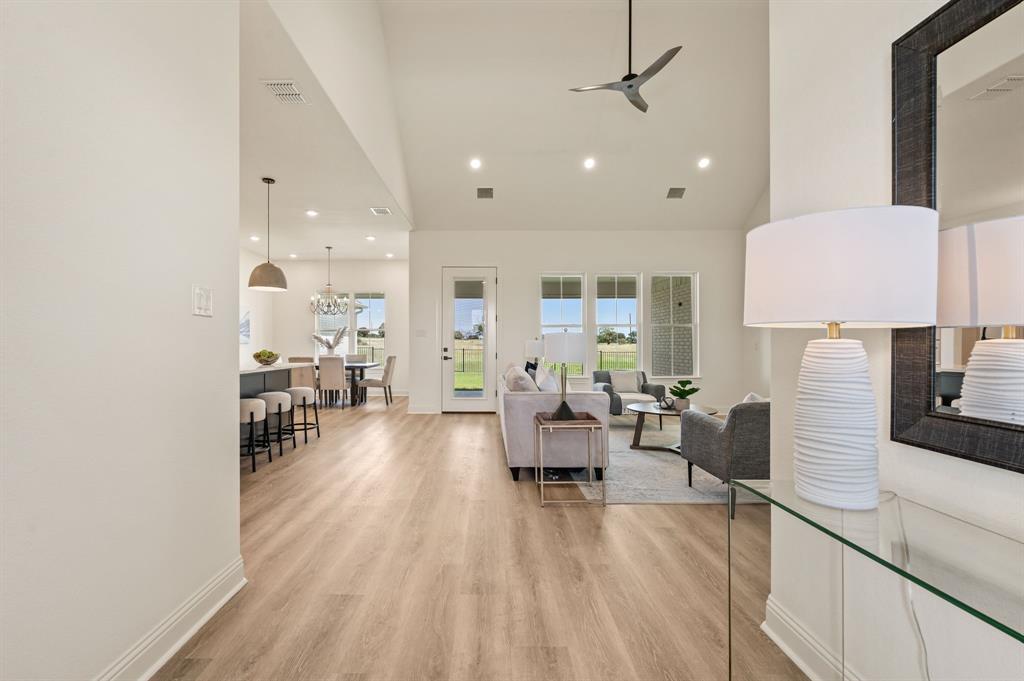 2705 Gospel Road Tolar, TX 76476 - Photo 8 of 36 Open-concept living area featuring luxury vinyl plank flooring, vaulted ceilings, recessed lighting, and a modern ceiling fan