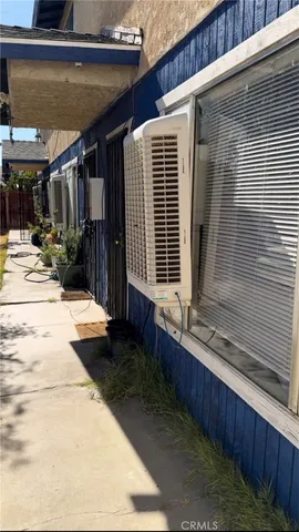 a view of house with backyard and sitting area
