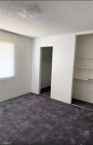 an empty room with a bench and a window