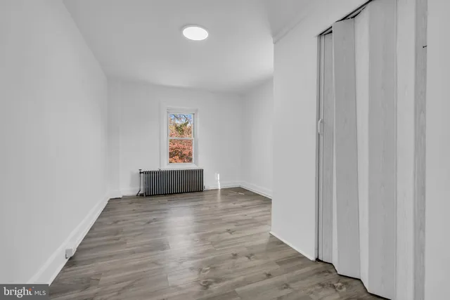 a view of a livingroom with wooden floor and a window