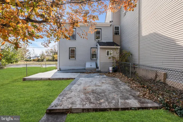 a view of a house with backyard and a tree