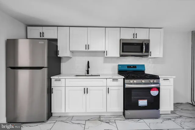 a kitchen with a stove microwave and refrigerator