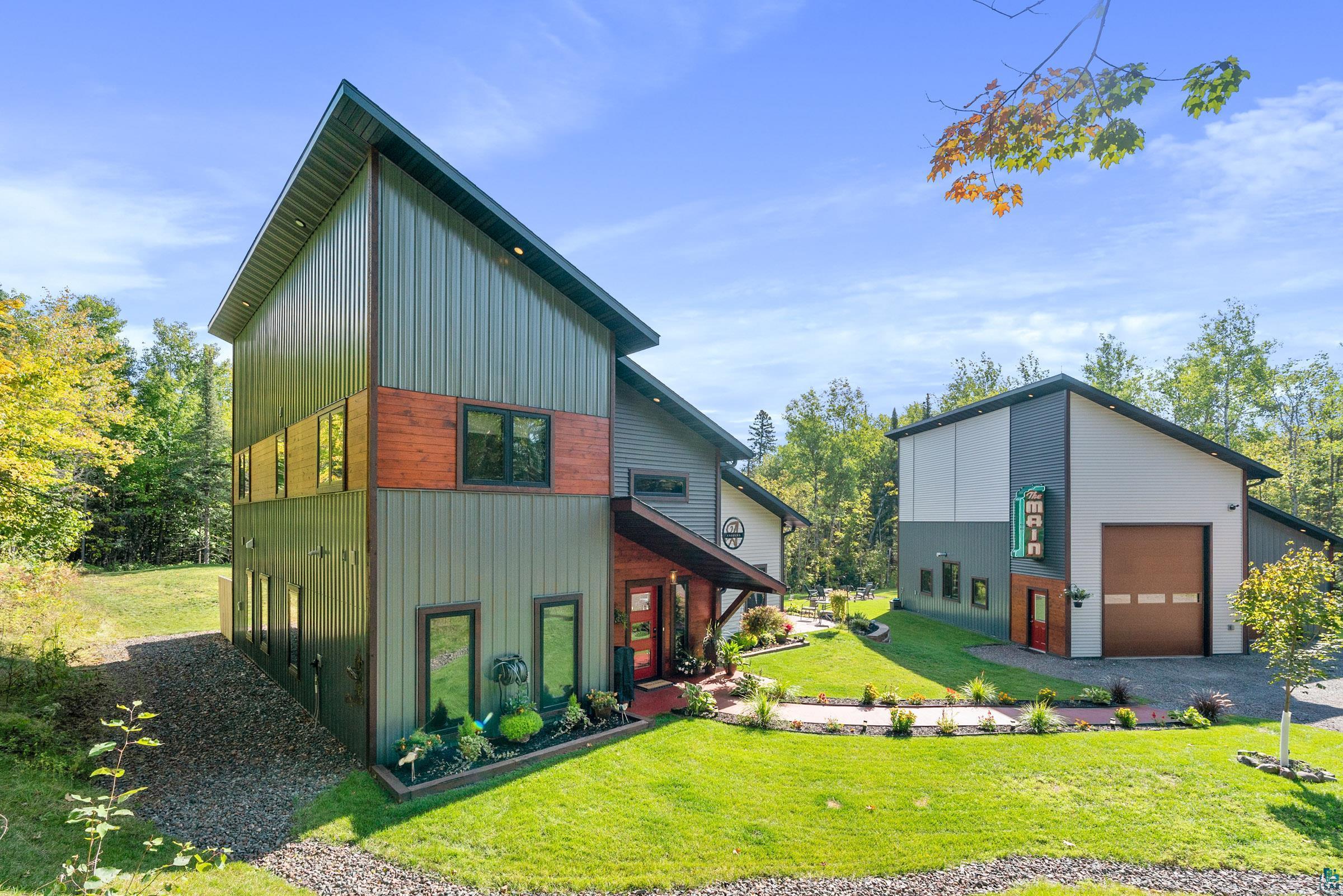5196 Eagle Lake Road Duluth, MN 55803 - Photo 2 of 50 Back of property featuring a garage and a lawn