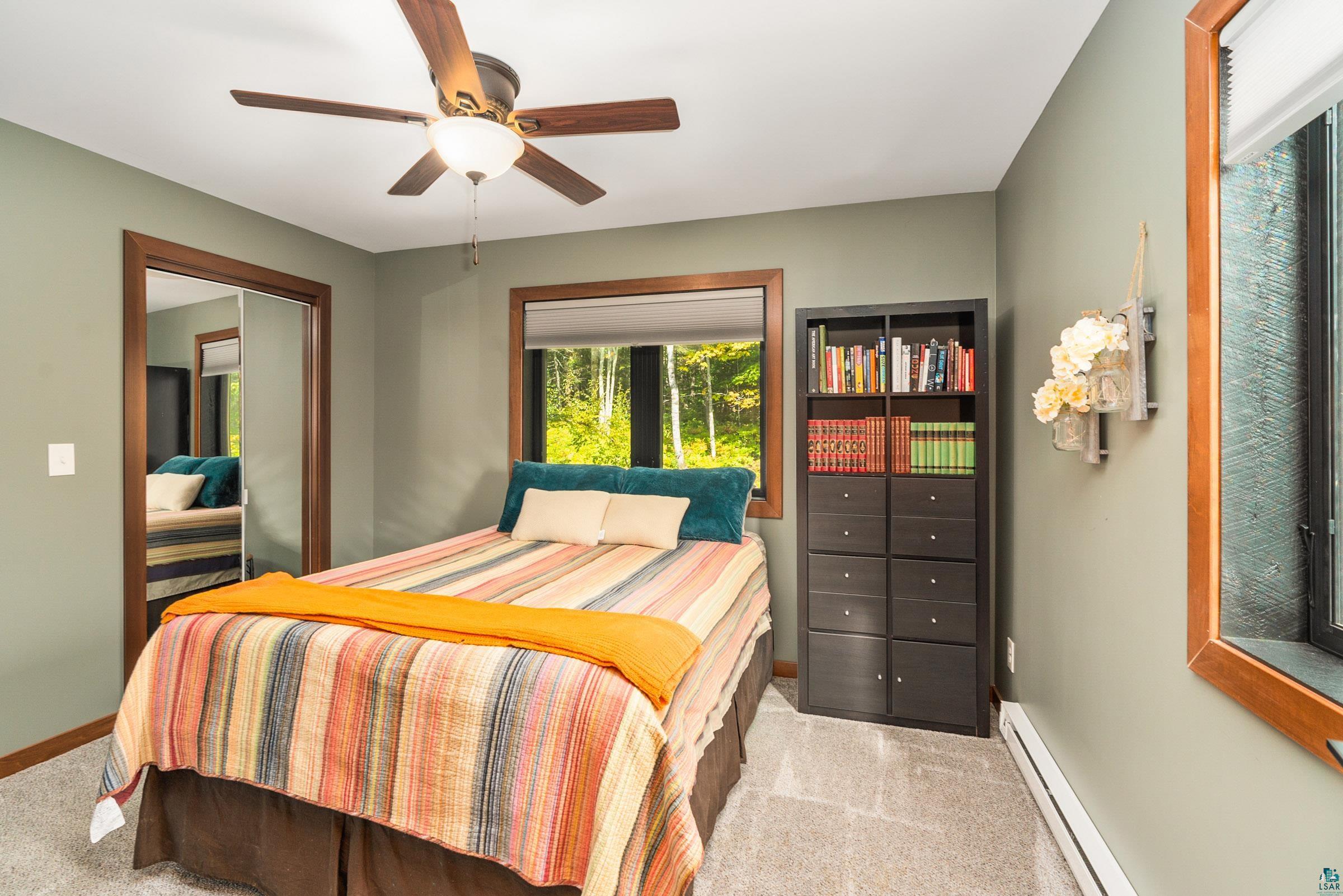 5196 Eagle Lake Road Duluth, MN 55803 - Photo 26 of 50 Carpeted bedroom featuring a baseboard heating unit, a closet, and ceiling fan