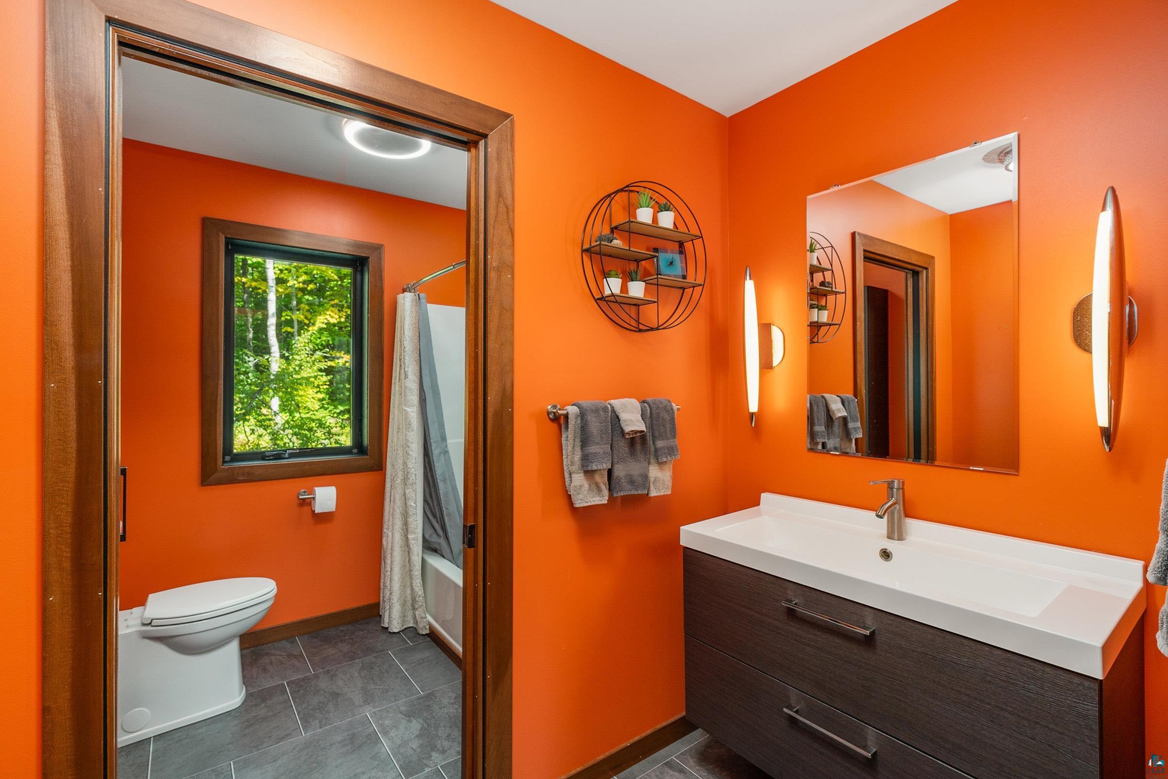 5196 Eagle Lake Road Duluth, MN 55803 - Photo 28 of 50 Full bathroom featuring toilet, tile patterned floors, vanity, and shower / bath combination with curtain
