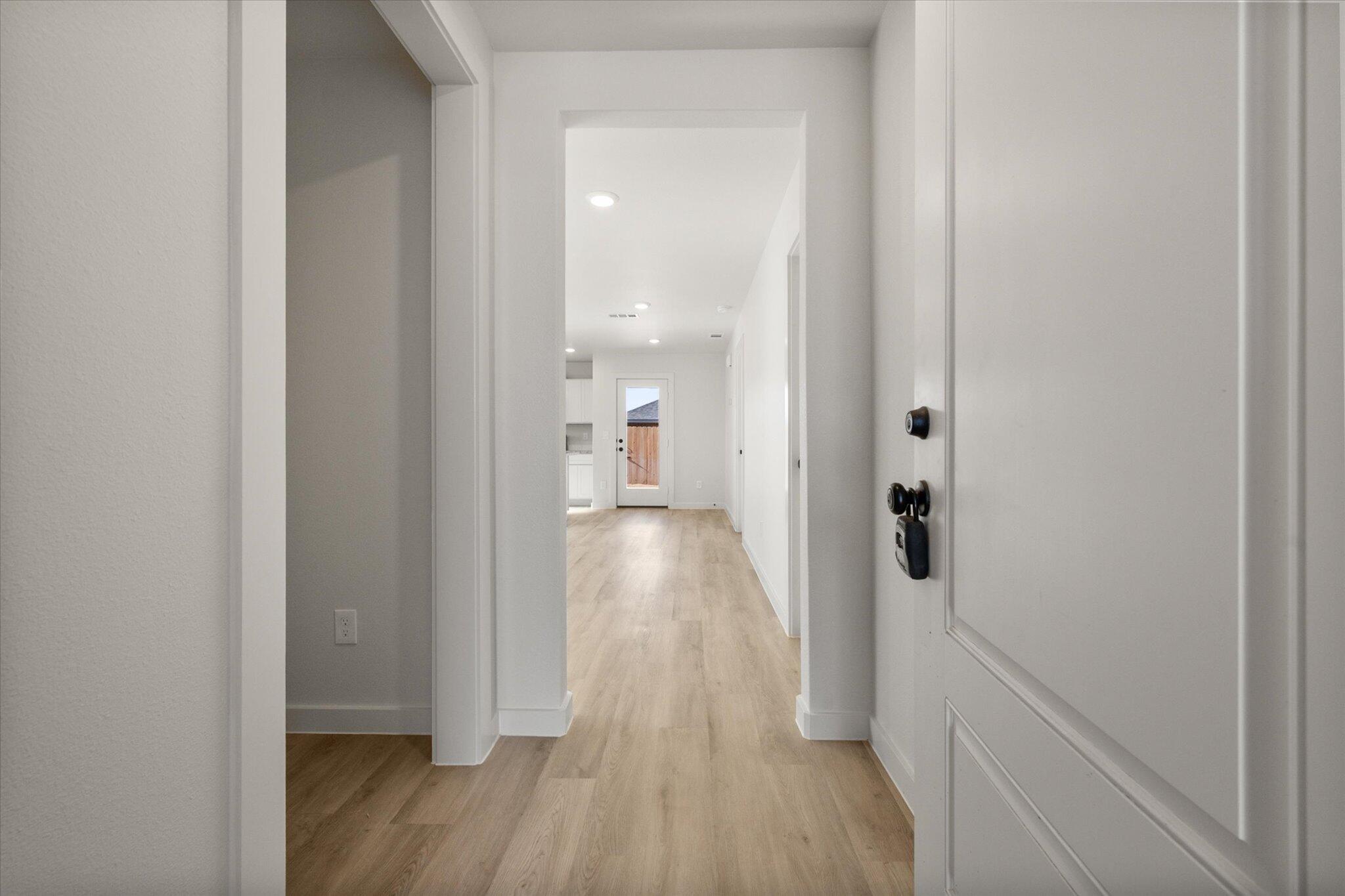 1603 North Clinton Avenue Lubbock, TX 79416 - Photo 2 of 14 a view of a hallway with wooden floor and staircase