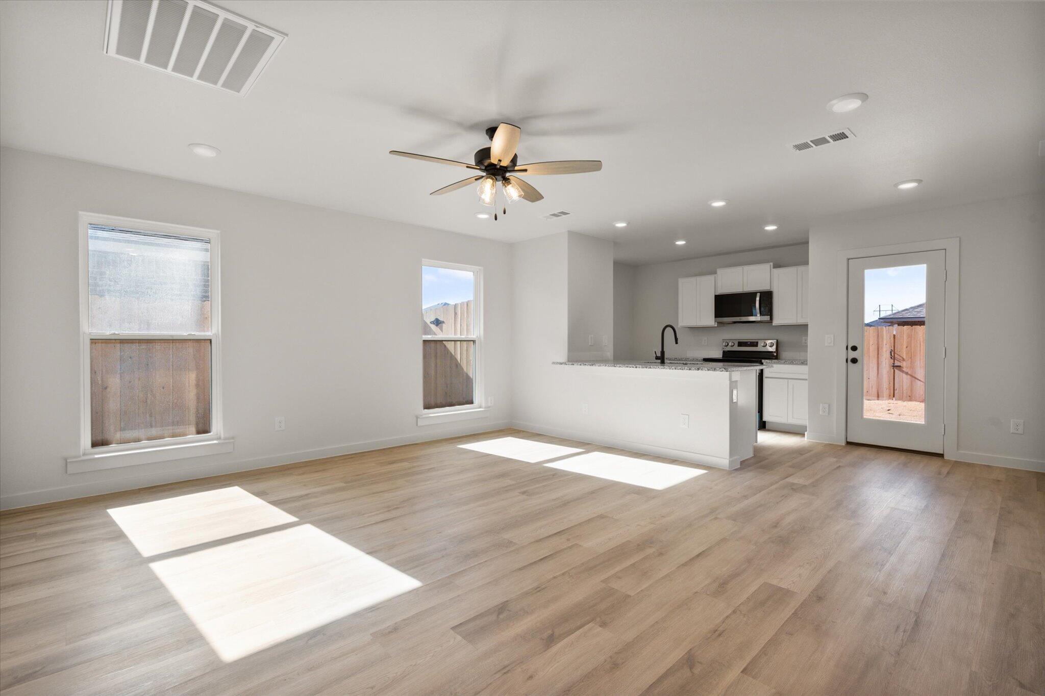 1603 North Clinton Avenue Lubbock, TX 79416 - Photo 3 of 14 a view of an empty room with kitchen and window