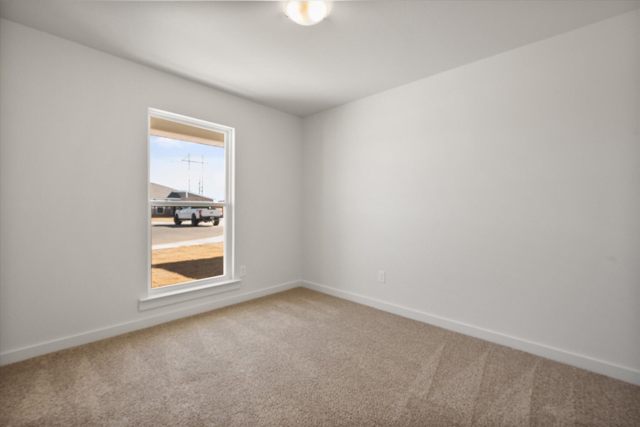 1603 North Clinton Avenue Lubbock, TX 79416 - Photo 9 of 14 an empty room with a window