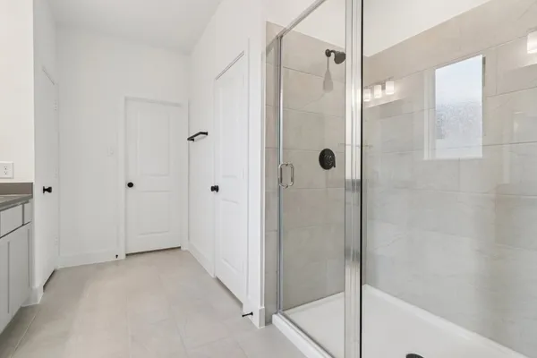 a view of a bathroom with a glass shower door
