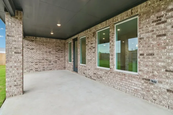 a view of a brick house with a large window