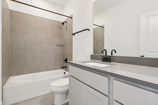 an empty room with white cabinet and windows