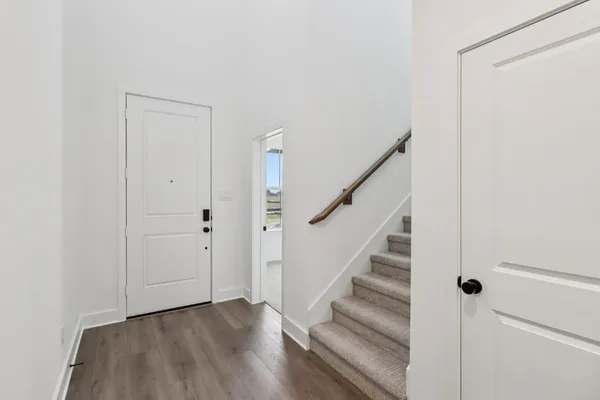 a view of entryway with wooden floor