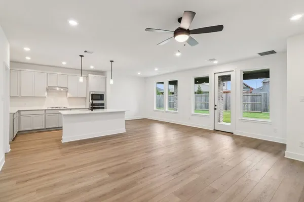 a view of kitchen with cabinets and wooden floor