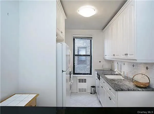 a kitchen with cabinets and window