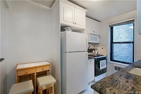 a kitchen with a refrigerator and a stove