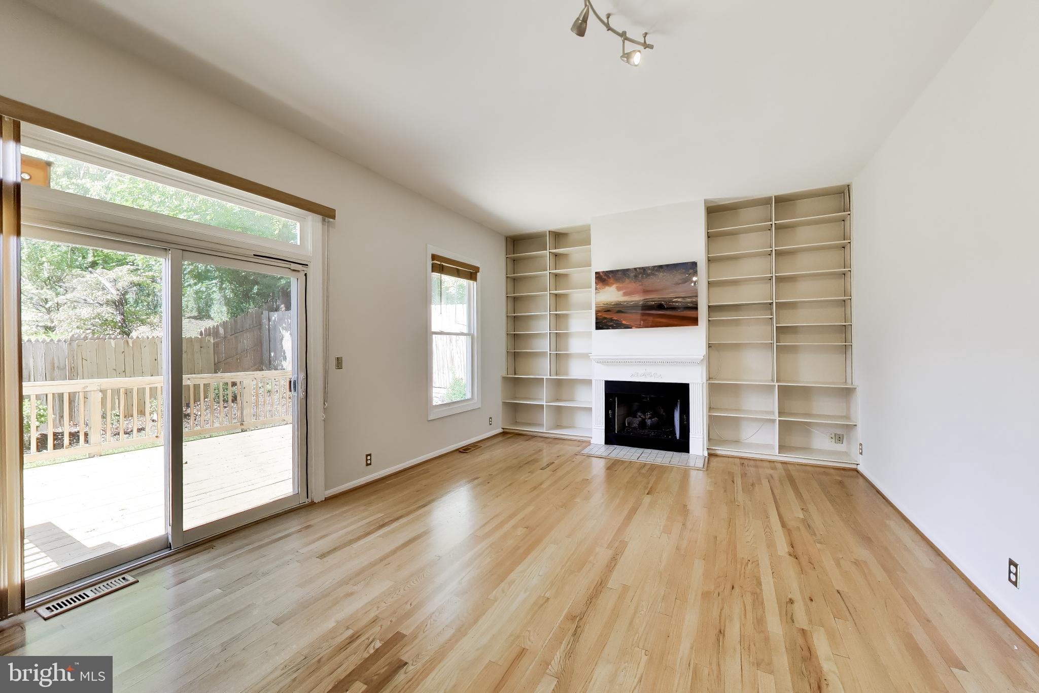 11906 Claridge Road Silver Spring, MD 20902 - Photo 15 of 41 Family room with gas fireplace and built-ins