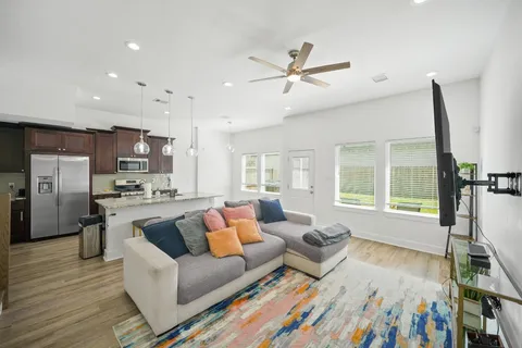 a living room with furniture and kitchen view