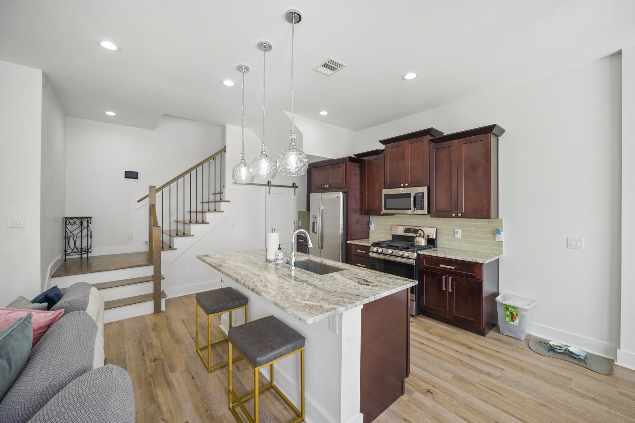 4402 McKinley Street, Unit B Houston, TX 77051 - Photo 3 of 21 a kitchen with stainless steel appliances kitchen island granite countertop a stove a sink and a refrigerator