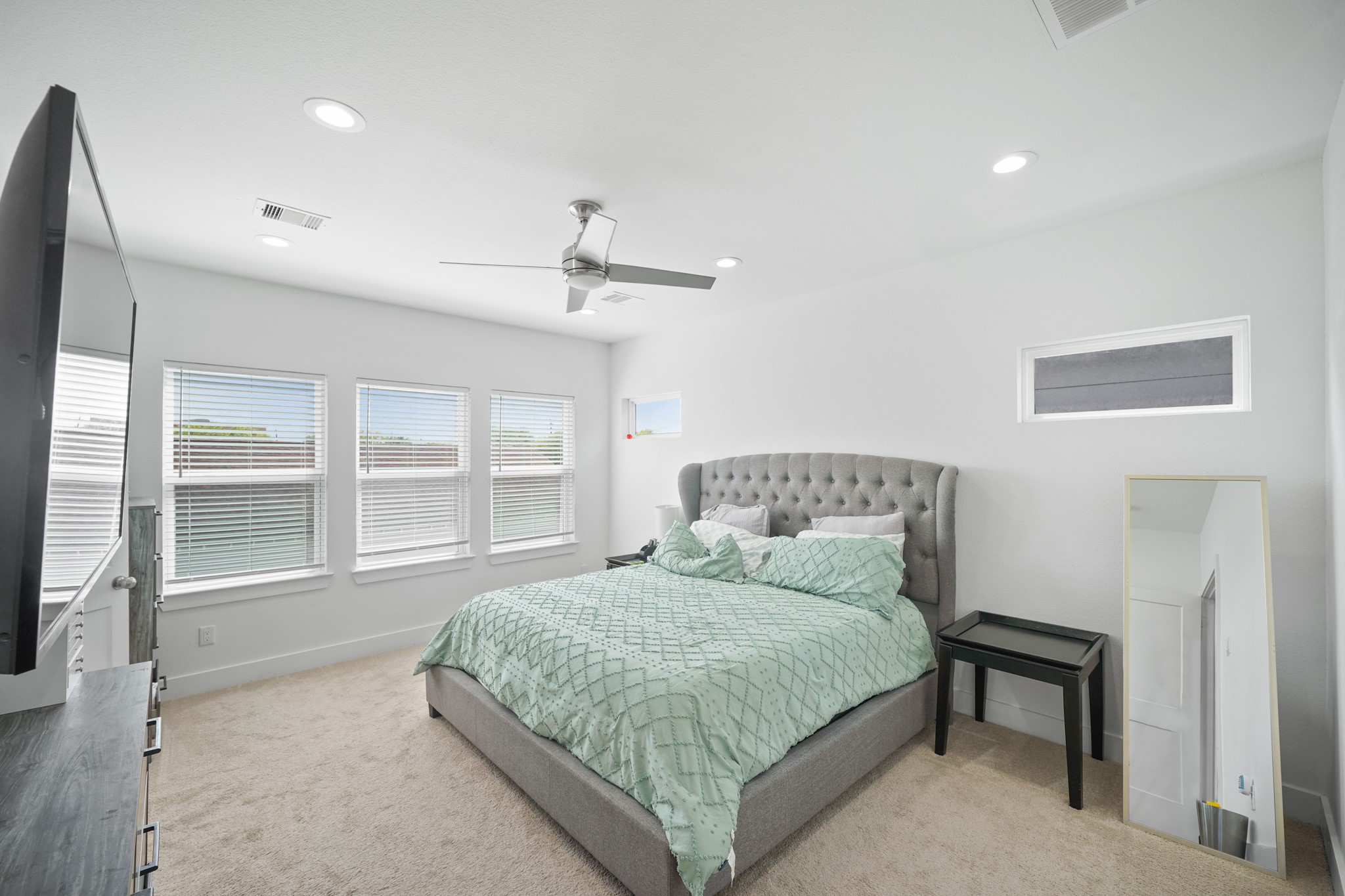 4402 McKinley Street, Unit B Houston, TX 77051 - Photo 7 of 21 a bedroom with a large bed and balcony