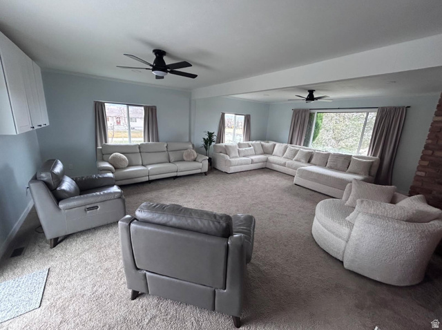 4468 North Droubay Road Tooele, UT 84074 - Photo 13 of 60 Spacious room featuring carpeting, multiple windows, exposed brick accent, and ceiling fans