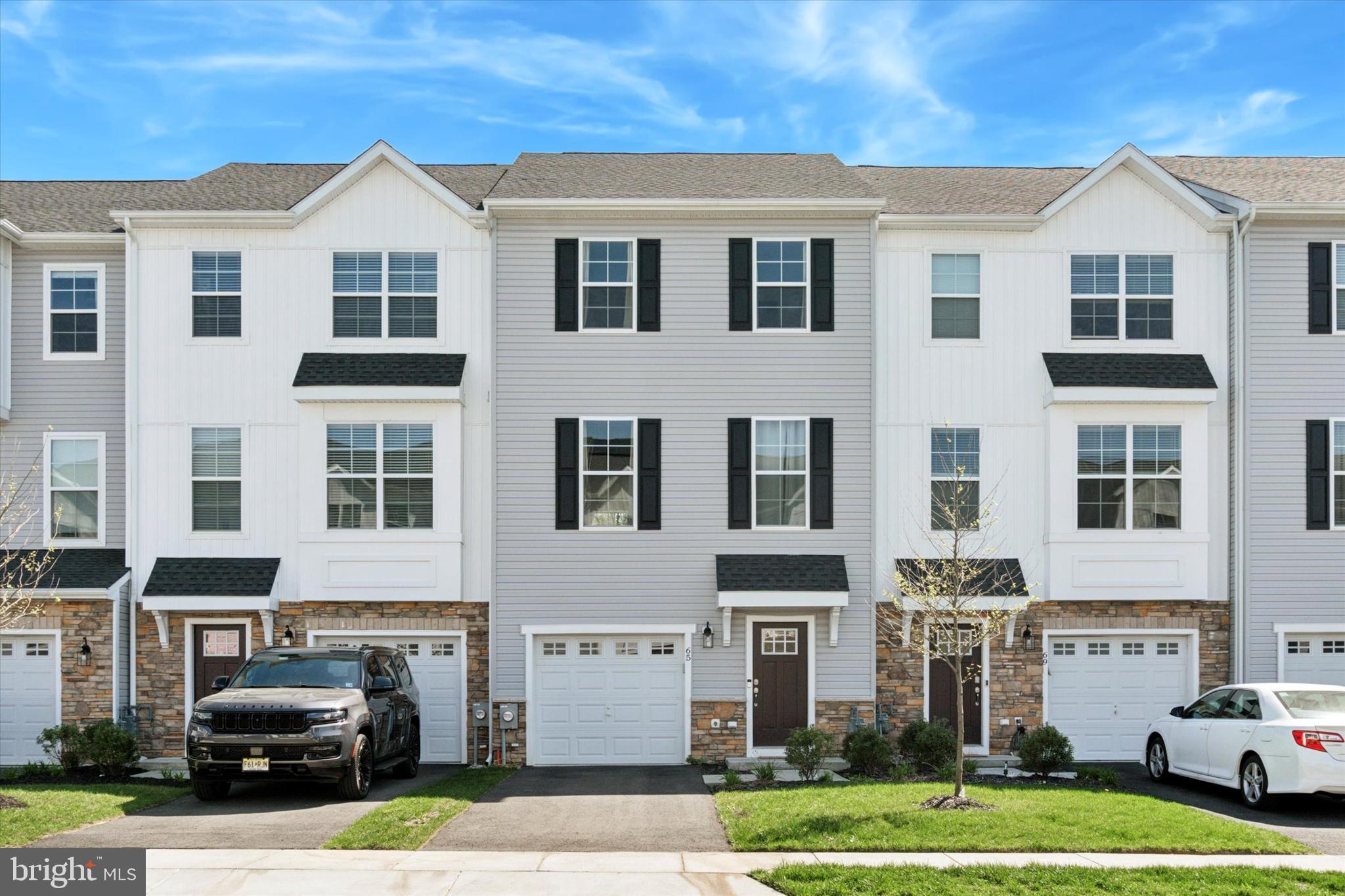 a front view of a residential apartment building with a yard