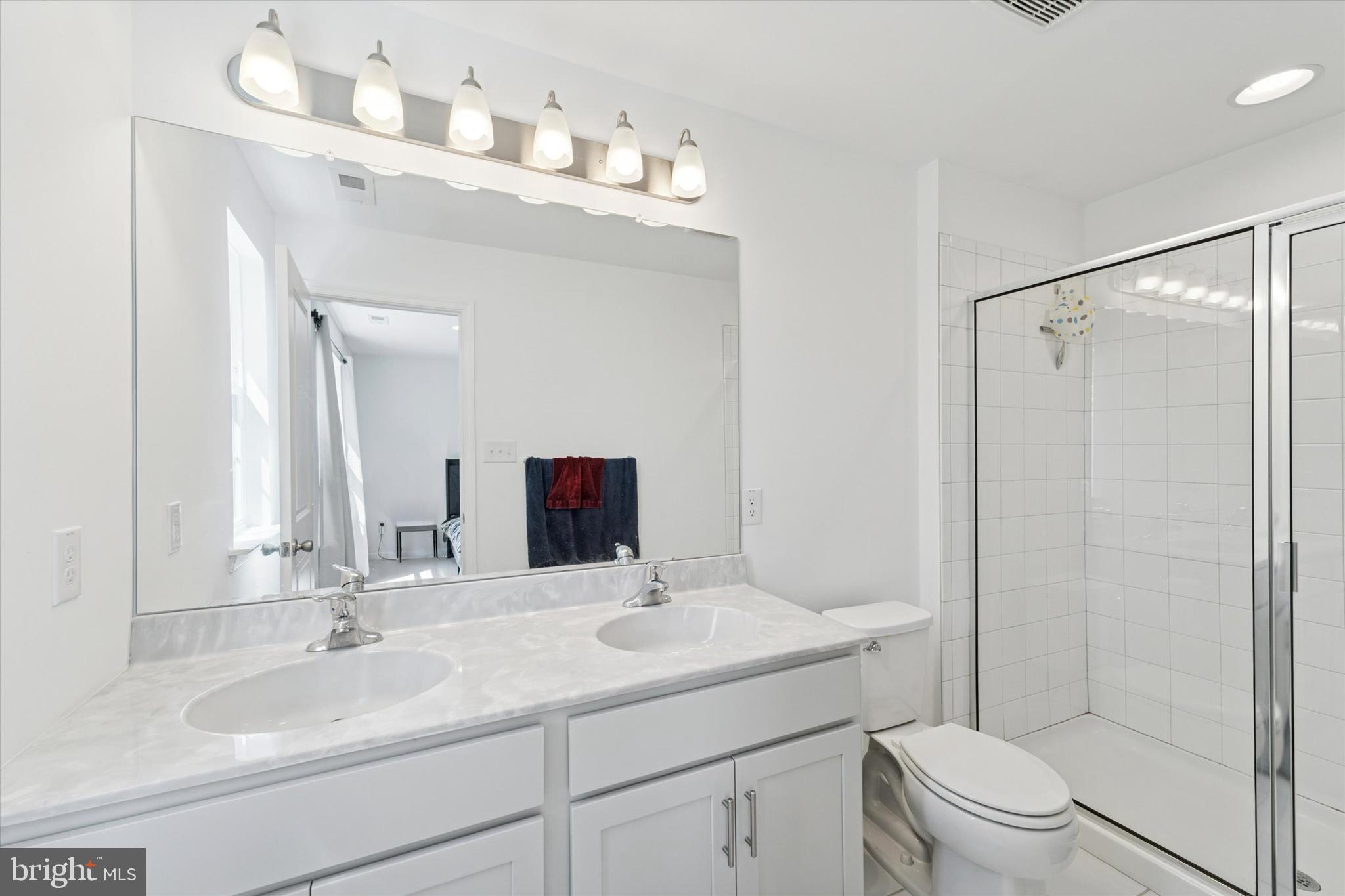 65 Aviary Road Thorofare, NJ 08086 - Photo 13 of 16 a bathroom with a sink a toilet and shower