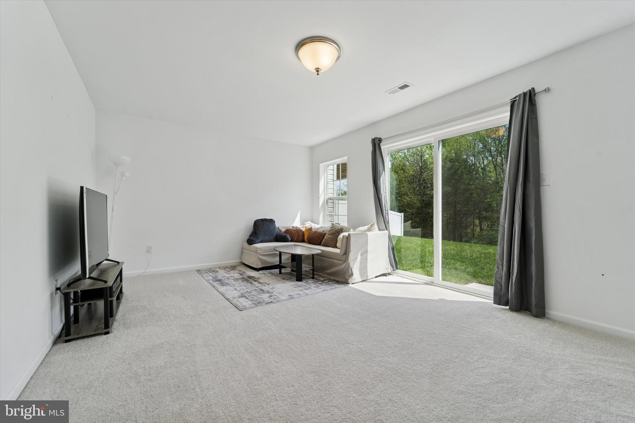65 Aviary Road Thorofare, NJ 08086 - Photo 15 of 16 a living room with furniture tv and a large window