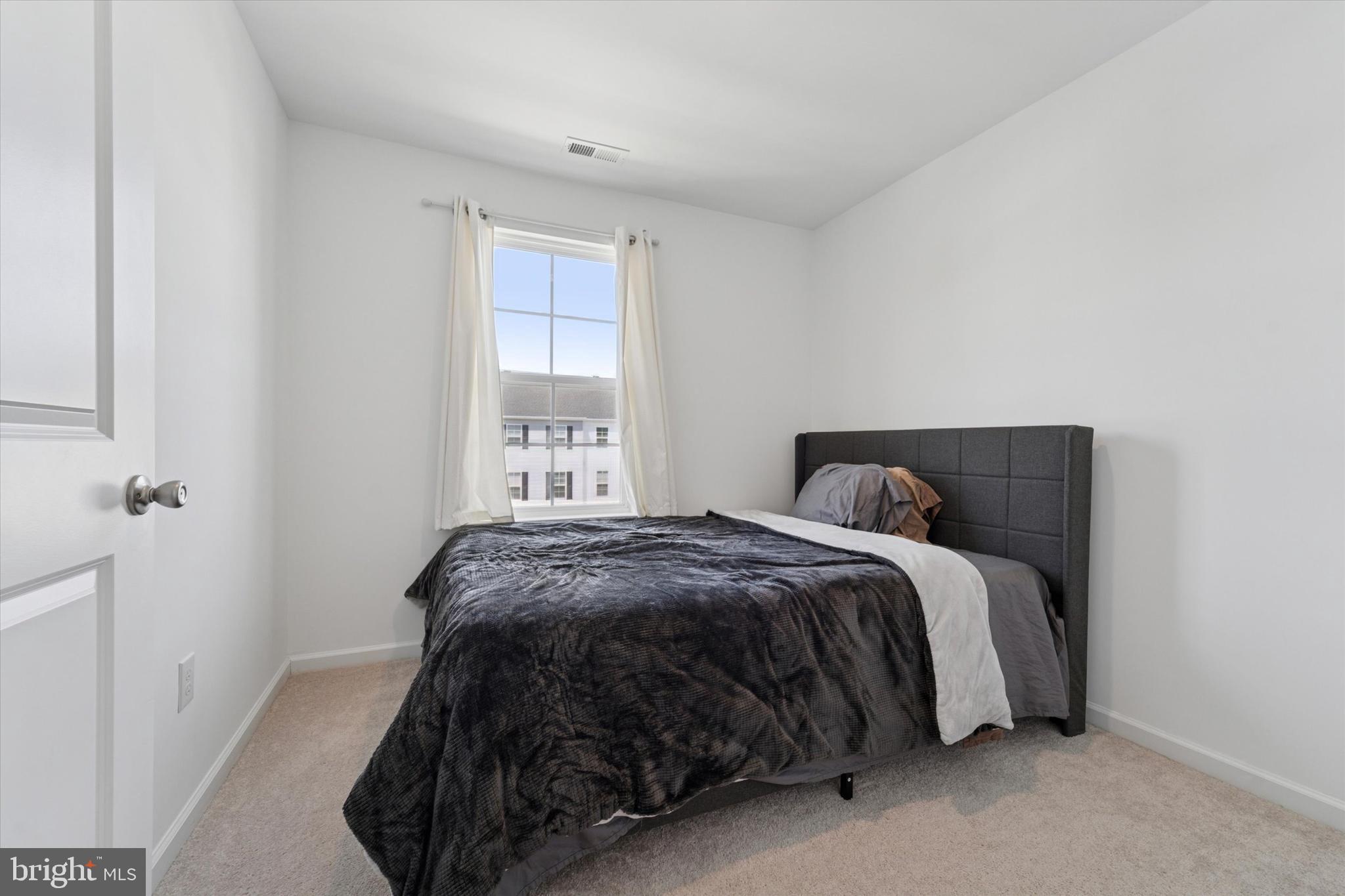 65 Aviary Road Thorofare, NJ 08086 - Photo 10 of 16 a bed sitting in a bedroom next to a window