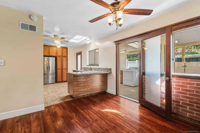 a kitchen with stainless steel appliances granite countertop a sink and a microwave