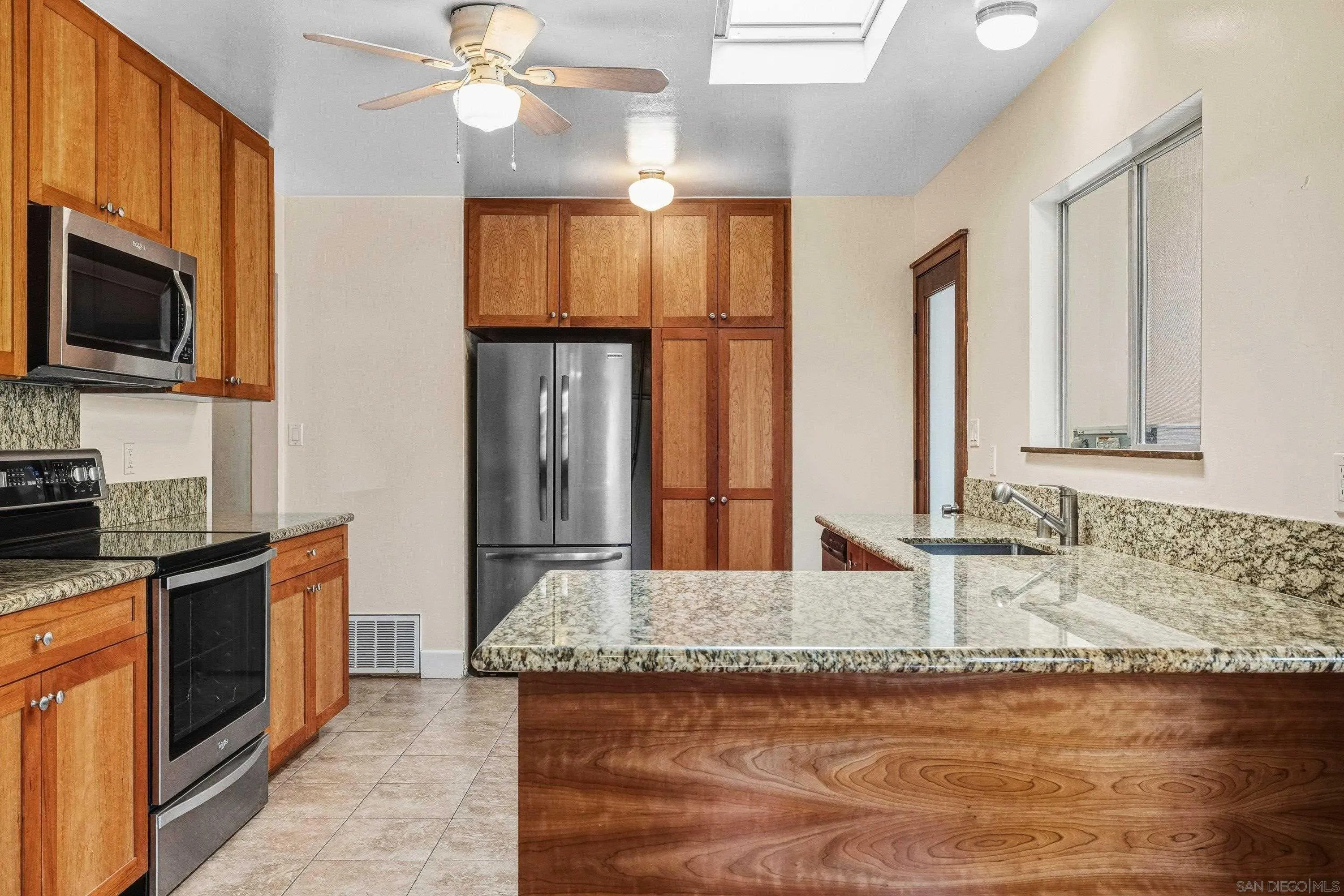 1491 Louise Drive Alpine, CA 91901 - Photo 13 of 45 a kitchen with stainless steel appliances granite countertop a sink and a microwave