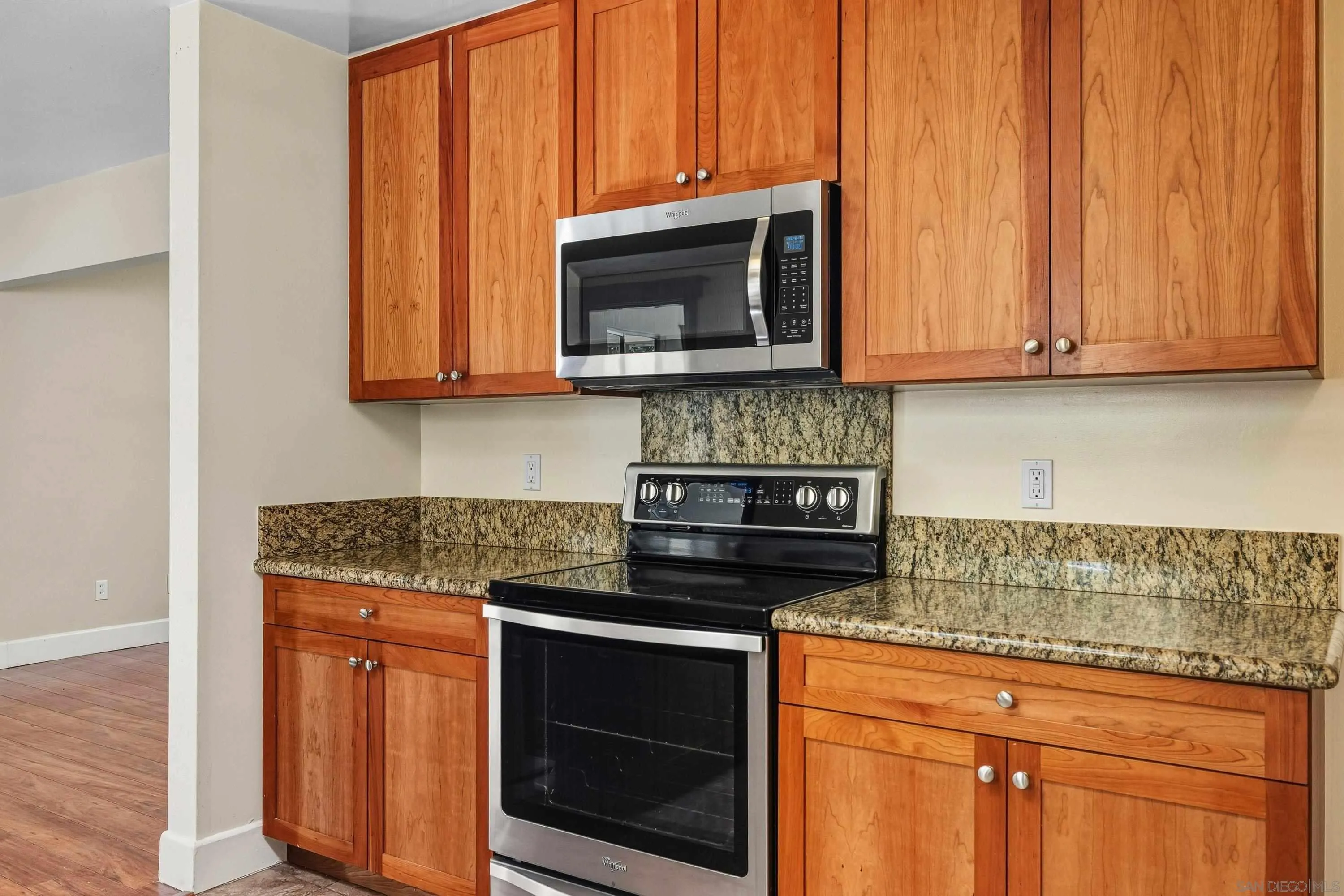 1491 Louise Drive Alpine, CA 91901 - Photo 14 of 45 a kitchen with stainless steel appliances granite countertop a stove microwave and cabinets
