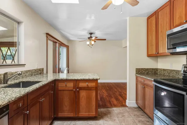 a bathroom with a granite countertop sink and mirror