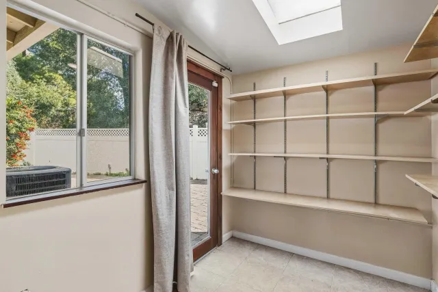 a view of a room with shelves on the wall