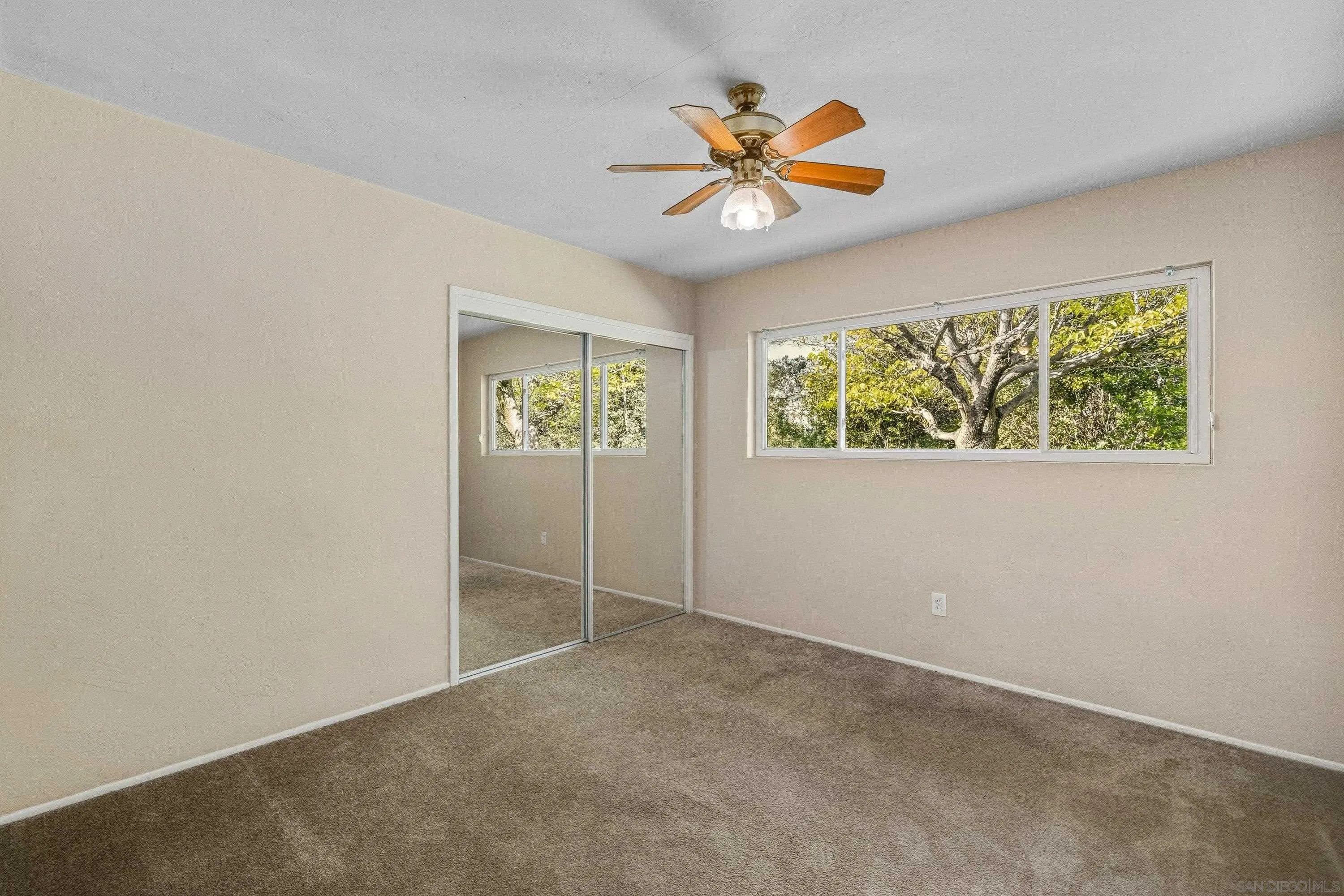1491 Louise Drive Alpine, CA 91901 - Photo 22 of 45 an empty room with windows and chandelier fan