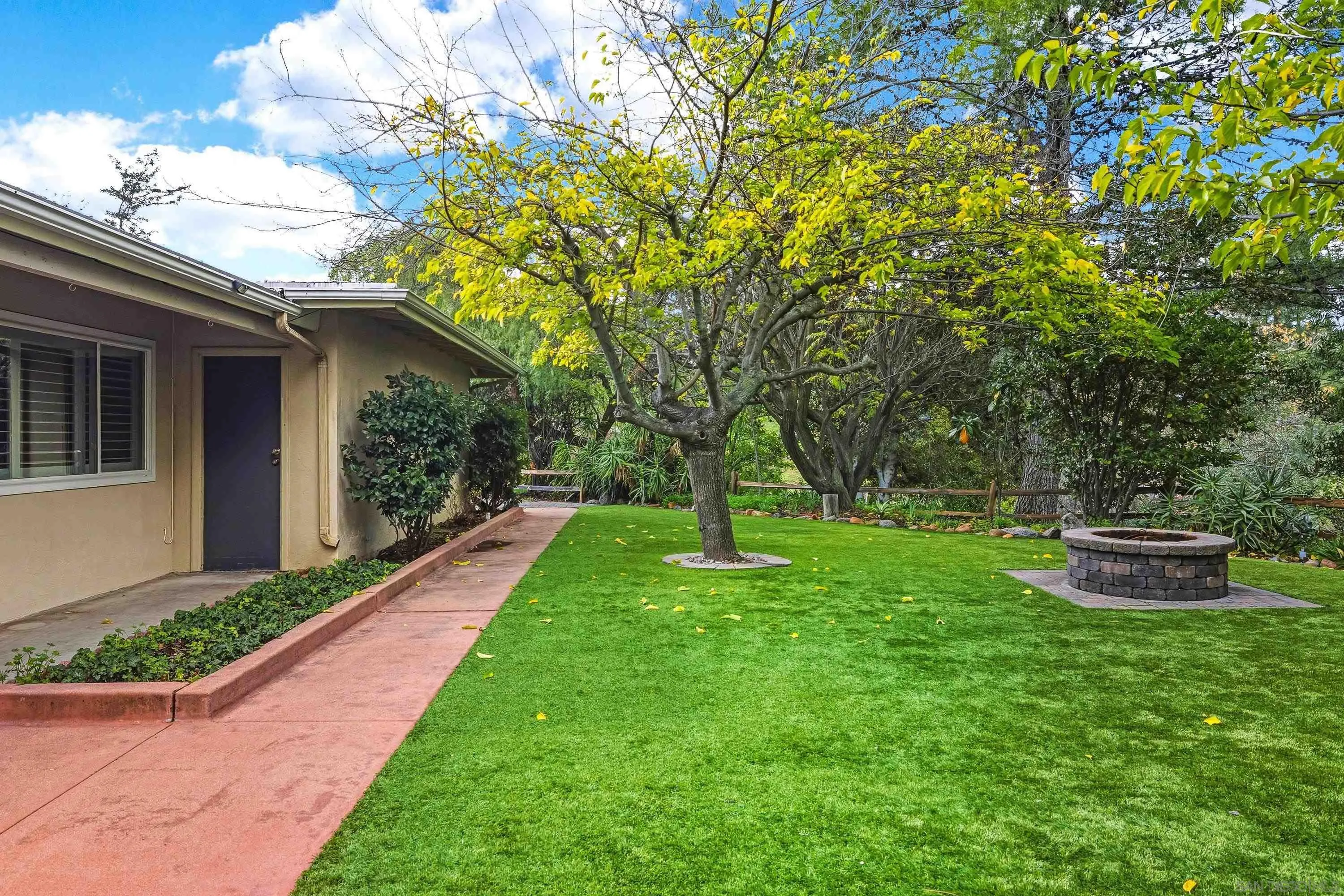 1491 Louise Drive Alpine, CA 91901 - Photo 39 of 45 a view of a backyard with table and chairs potted plants and large tree