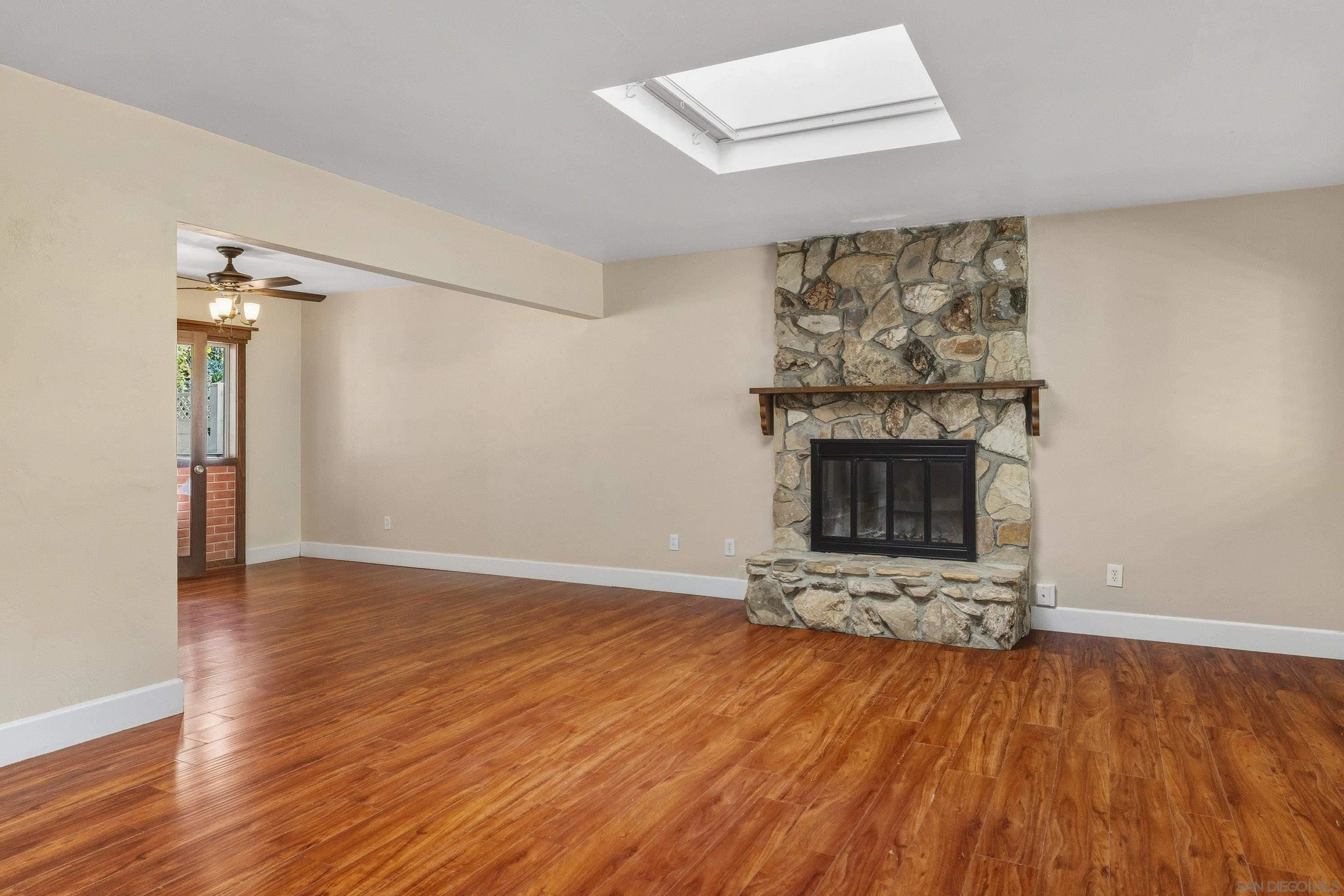 1491 Louise Drive Alpine, CA 91901 - Photo 7 of 45 an empty room with wooden floor fireplace and windows