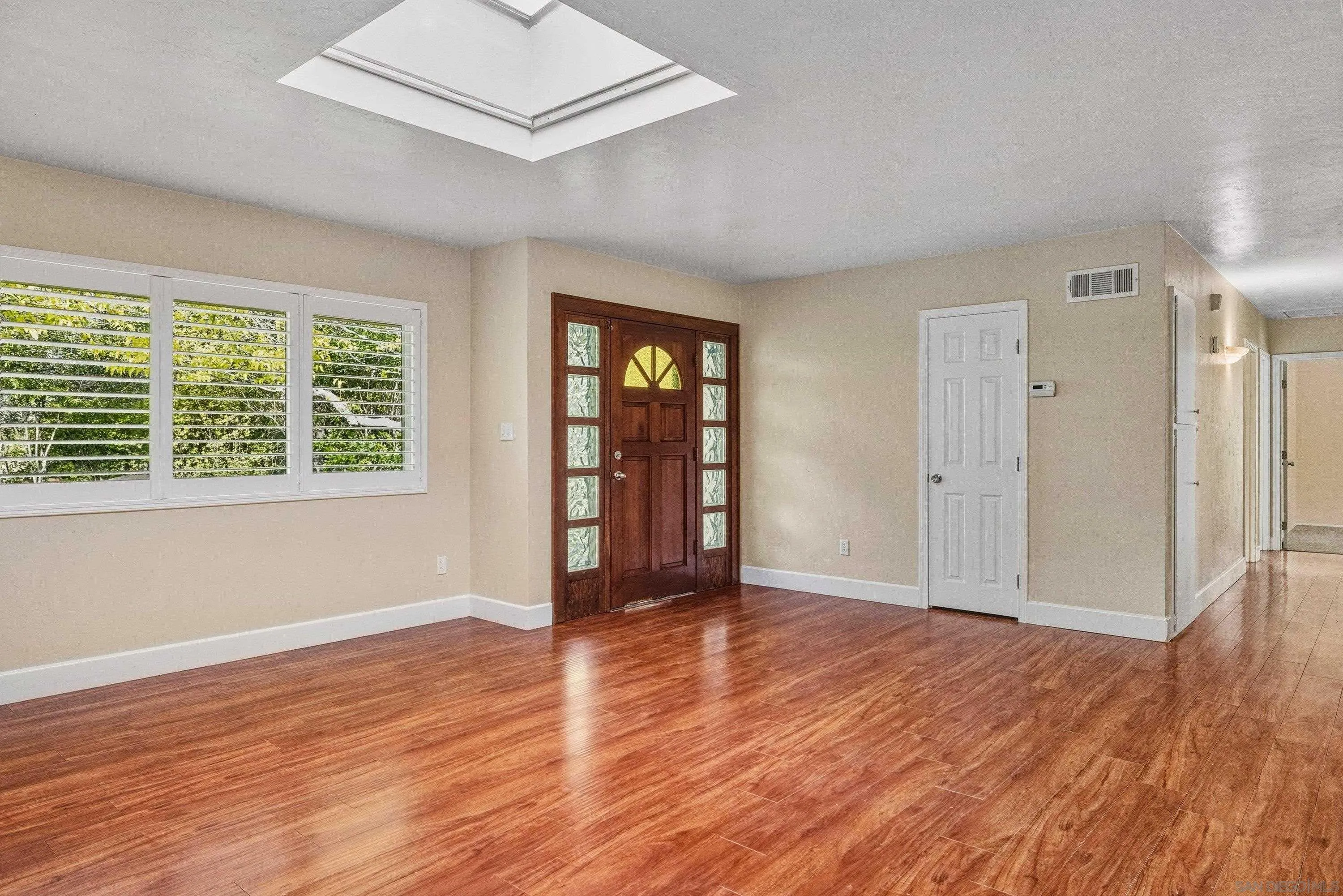 1491 Louise Drive Alpine, CA 91901 - Photo 9 of 45 an empty room with wooden floor and windows