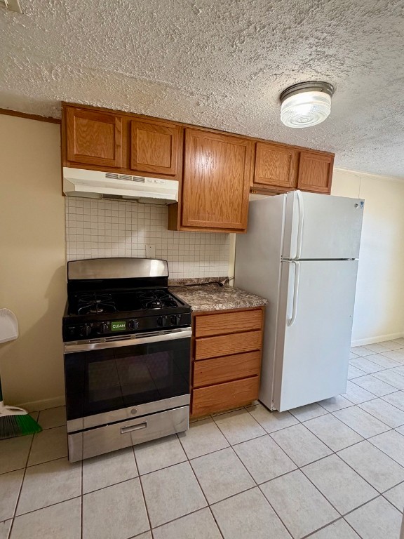 1608 Dyer Avenue Rosenberg, TX 77471 - Photo 7 of 16 a kitchen with a stove a refrigerator and a cabinets