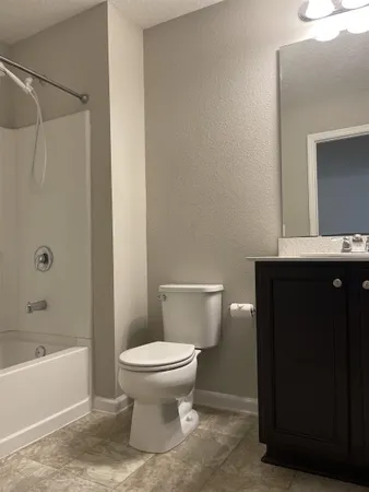 a bathroom with a toilet and a bathtub