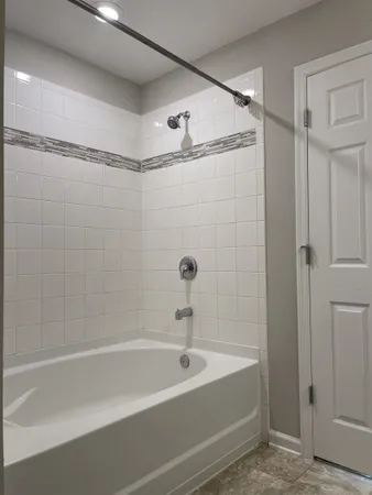 a bathroom with a shower and a bath tub