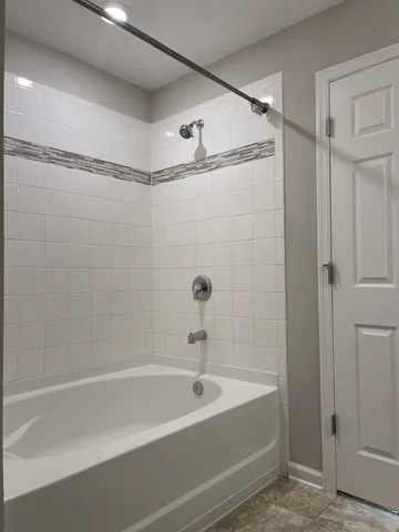 a bathroom with a shower and a bath tub