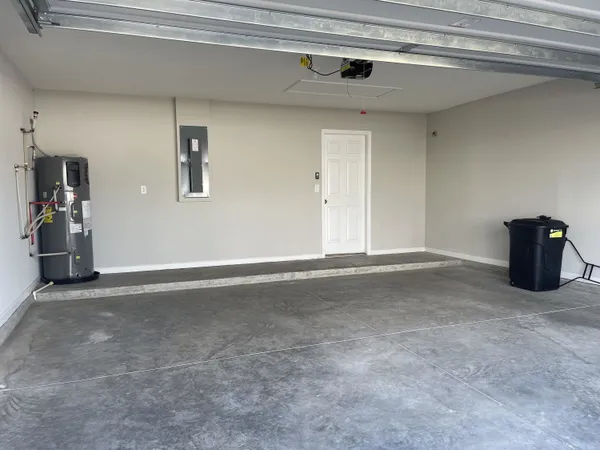 a front view of a house with yard and garage